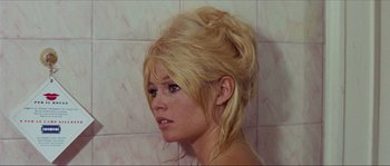 Movie still from “Contempt” (1963), directed by Jean-Luc Godard – A woman with blonde hair is looking into the distance; Close Up shot, High angle
