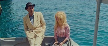Movie still from “Contempt” (1963), directed by Jean-Luc Godard – A man and a woman sitting on a boat in the water; Medium shot, High angle