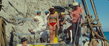 Movie still from “Contempt” (1963), directed by Jean-Luc Godard – A woman in a red bathing suit is being filmed; Wide shot, High angle