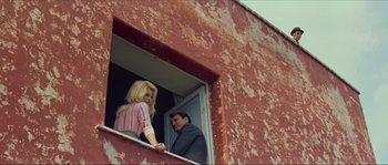 Movie still from “Contempt” (1963), directed by Jean-Luc Godard – A man and a woman looking out of a window; Medium shot, Low angle