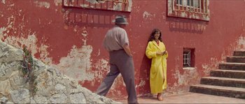 Movie still from “Contempt” (1963), directed by Jean-Luc Godard – An old man and a woman in a yellow robe; Wide shot, Low angle