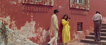 Movie still from “Contempt” (1963), directed by Jean-Luc Godard – A man and a woman standing next to each other in front of a building; Wide shot, Low angle