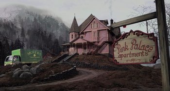 Movie still from “Coraline” (2009), directed by Henry Selick – A large pink house sitting on top of a dirt hill; Extreme Wide shot, High angle