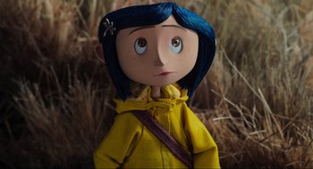 Movie still from “Coraline” (2009), directed by Henry Selick – A blue haired doll in a yellow raincoat; Close Up shot, High angle