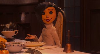Movie still from “Coraline” (2009), directed by Henry Selick – A woman sitting at a dinner table with a bell in front of her face; Medium shot, Over the shoulder angle