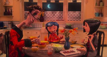 Movie still from “Coraline” (2009), directed by Henry Selick – A table set up for a family dinner with a doll on top of the table; Wide shot, Over the shoulder angle