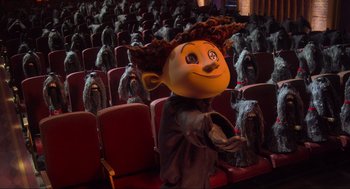 Movie still from “Coraline” (2009), directed by Henry Selick – A man that is sitting in a theater; Wide shot, High angle