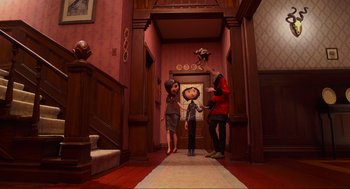 Movie still from “Coraline” (2009), directed by Henry Selick – A group of people standing in a room; Wide shot, Over the shoulder angle