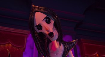 Movie still from “Coraline” (2009), directed by Henry Selick – A doll with long black hair and a black dress; Close Up shot, Low angle