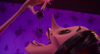 Movie still from “Coraline” (2009), directed by Henry Selick – A woman holding a key to a pink elephant; Extreme Close Up shot, Overhead angle