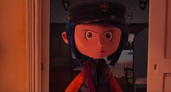 Movie still from “Coraline” (2009), directed by Henry Selick – A doll wearing a black hat; Close Up shot, Over the shoulder angle