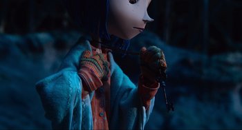 Movie still from “Coraline” (2009), directed by Henry Selick – A person holding a key in their hand; Close Up shot, Over the shoulder angle