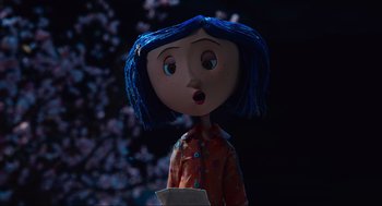 Movie still from “Coraline” (2009), directed by Henry Selick – A blue haired doll with a surprised look on its face; Medium shot, Over the shoulder angle