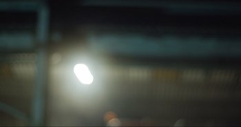 Movie still from “Cow” (2021), directed by Andrea Arnold – A blurry image of a street light in the dark; Extreme Close Up shot, Low angle