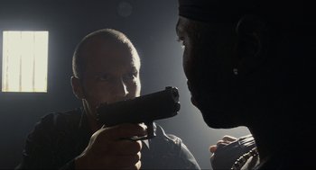 Movie still from “Crank” (2006), directed by Mark Neveldine – A man holding a gun up to another man's face; Close Up shot, Low angle