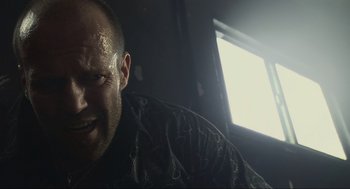 Movie still from “Crank” (2006), directed by Mark Neveldine – A person wearing a black shirt; Close Up shot, Low angle