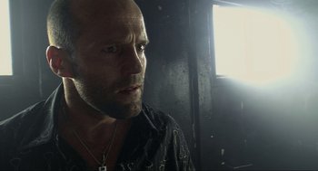 Movie still from “Crank” (2006), directed by Mark Neveldine – A man with a beard is looking at the camera; Close Up shot, Low angle