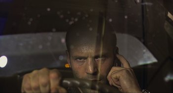 Movie still from “Crank” (2006), directed by Mark Neveldine – A man with a beard is talking on a cell phone; Close Up shot, Over the shoulder angle