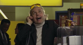 Movie still from “Crank” (2006), directed by Mark Neveldine – A man wearing sunglasses talking on a cell phone; Close Up shot, Low angle