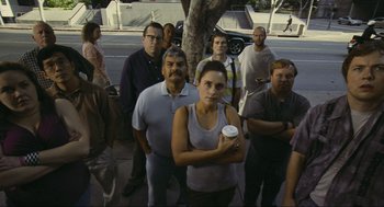 Movie still from “Crank” (2006), directed by Mark Neveldine – A group of people standing next to each other on the street; Medium shot, High angle