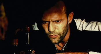 Movie still from “Crank” (2006), directed by Mark Neveldine – A person wearing a black shirt; Close Up shot, Low angle