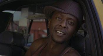 Movie still from “Crank” (2006), directed by Mark Neveldine – A person wearing a hat; Close Up shot, Low angle