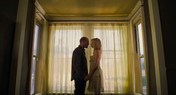 Movie still from “Crank” (2006), directed by Mark Neveldine – A man and a woman standing next to each other; Medium shot, Low angle