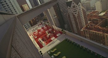 Movie still from “Crank” (2006), directed by Mark Neveldine – An aerial view of an office building with lawn chairs; Extreme Wide shot, Overhead angle
