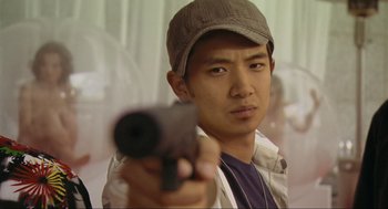 Movie still from “Crank” (2006), directed by Mark Neveldine – A man holding a gun in his hand; Close Up shot, Low angle