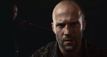Movie still from “Crank” (2006), directed by Mark Neveldine – A man with a bald head is looking at the camera; Close Up shot, Low angle