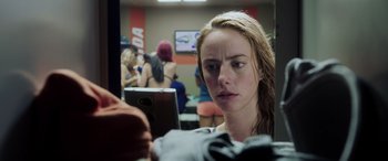 Movie still from “Crawl” (2019), directed by Alexandre Aja – A woman is looking at a computer screen in a room; Close Up shot, Over the shoulder angle
