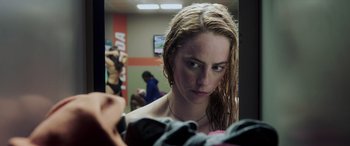 Movie still from “Crawl” (2019), directed by Alexandre Aja – A woman looking at herself in the mirror; Close Up shot, Over the shoulder angle