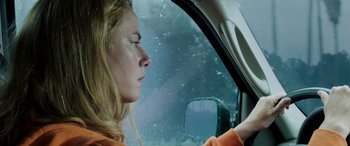 Movie still from “Crawl” (2019), directed by Alexandre Aja – A woman driving a car in the rain; Close Up shot, Low angle