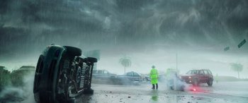 Movie still from “Crawl” (2019), directed by Alexandre Aja – A person in a yellow jacket standing in the rain; Extreme Wide shot, Low angle