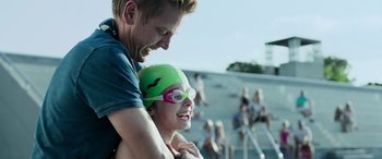 Movie still from “Crawl” (2019), directed by Alexandre Aja – A man and a girl wearing swimming goggles; Close Up shot, Over the shoulder angle