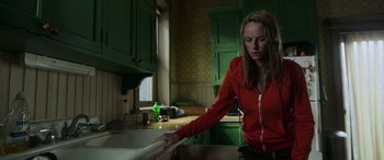 Movie still from “Crawl” (2019), directed by Alexandre Aja – A woman standing in a kitchen next to a sink; Medium shot, Low angle