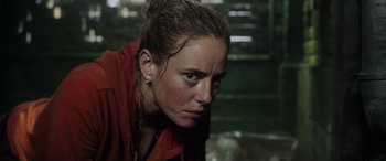 Movie still from “Crawl” (2019), directed by Alexandre Aja – A person wearing a red jacket; Close Up shot, Low angle