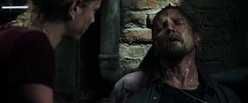 Movie still from “Crawl” (2019), directed by Alexandre Aja – A man and a woman are looking at each other; Close Up shot, High angle