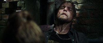 Movie still from “Crawl” (2019), directed by Alexandre Aja – A man is laying on a bed with blood on his face; Close Up shot, Overhead angle
