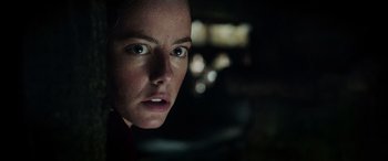 Movie still from “Crawl” (2019), directed by Alexandre Aja – A woman's face in the dark; Close Up shot, Low angle