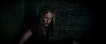 Movie still from “Crawl” (2019), directed by Alexandre Aja – A woman with a knife stuck in her mouth; Close Up shot, Low angle