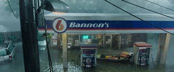 Movie still from “Crawl” (2019), directed by Alexandre Aja – A gas station flooded with water from a boat; Extreme Wide shot, High angle