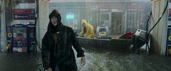 Movie still from “Crawl” (2019), directed by Alexandre Aja – Two people in a boat on a flooded street; Wide shot, Low angle