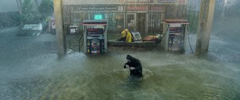 Movie still from “Crawl” (2019), directed by Alexandre Aja – A man is standing in a flooded street; Extreme Wide shot, High angle