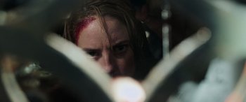 Movie still from “Crawl” (2019), directed by Alexandre Aja – A person with blood on their face; Extreme Close Up shot, Low angle