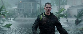 Movie still from “Crawl” (2019), directed by Alexandre Aja – A man in a wet suit walking through a flooded area; Medium shot, Low angle