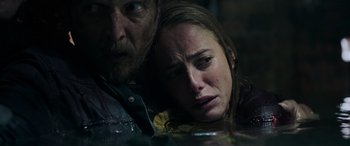Movie still from “Crawl” (2019), directed by Alexandre Aja – A man and a woman sitting next to each other; Close Up shot, High angle