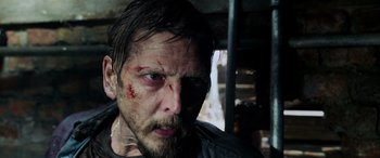 Movie still from “Crawl” (2019), directed by Alexandre Aja – A person with blood on his face; Close Up shot, Over the shoulder angle