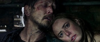Movie still from “Crawl” (2019), directed by Alexandre Aja – A man and a woman are laying on the ground; Close Up shot, Low angle