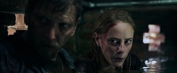 Movie still from “Crawl” (2019), directed by Alexandre Aja – A man and a woman with blood all over their faces; Close Up shot, Over the shoulder angle